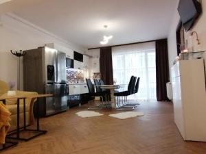 a kitchen and dining room with a table and chairs at Iris Vivo Mall in Cluj-Napoca +14 photos