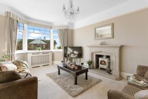 a living room with a couch and a fireplace at Family Home By The Sea in Torquay +29 photos