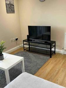a living room with a large flat screen tv at Holiday Flat in Central Slough near to London Heathrow and Windsor with Free Car Park in Slough