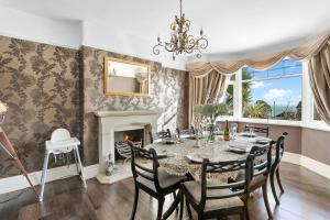 uma sala de jantar com uma mesa e uma lareira em Family Home By The Sea em Torquay
