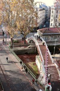 a bridge in a city with people walking on it at Le Citizen Hotel in Paris