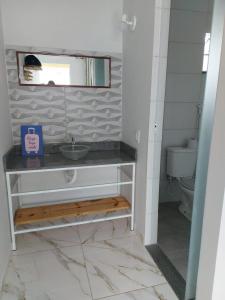 a bathroom with a sink and a toilet at Pousada Ostara in Alto Paraíso de Goiás +98 photos