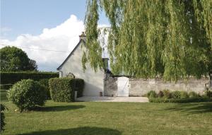 a white building with a tree hanging over it at Lovely Home In Saumur With Wifi in Saumur
