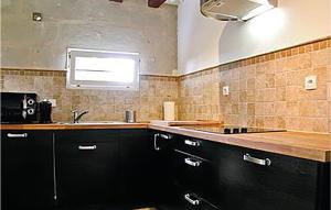 a kitchen with a sink and a counter top at Lovely Home In Saumur With Wifi in Saumur +4 photos