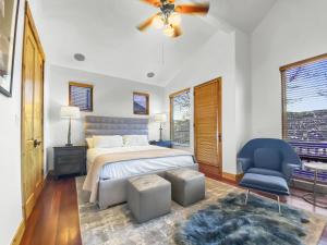 a bedroom with a bed and a blue chair at 502 A Gold Coast! townhouse in Park City