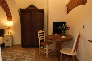 a dining room with a table and chairs and a room with a bed at Old Town Sibiu Apartment - Historical Center Residence in Sibiu
