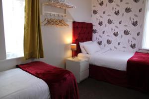 a hotel room with two beds and a window at Mardonia Hotel in Blackpool