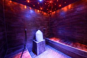 a room with a bathtub with lights on it at TALHEIMER Grias di & Hoamat since 1958 inklusive Therme TAUERN SPA & Jokercard in Saalbach Hinterglemm
