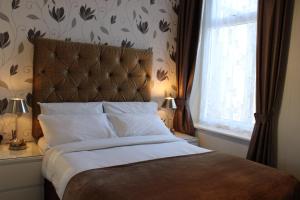 a bedroom with a large bed and a window at Mardonia Hotel in Blackpool