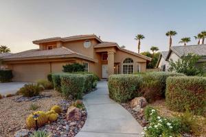 a house with a driveway in front of it at Sunset Disco: Large Pool/Spa @ Lush Family Retreat in La Quinta