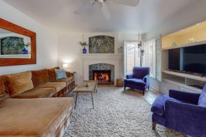 a living room with a couch and a fireplace at Sunset Disco: Large Pool/Spa @ Lush Family Retreat in La Quinta