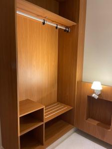 a closet with wooden panels and a lamp in a room at Salinas Exclusive Resort in Salinópolis