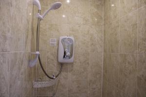 a shower with a phone in a bathroom at Mardonia Hotel in Blackpool