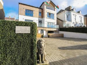 a lion statue in front of a building at Bryn Min Manton Bach in Caernarfon