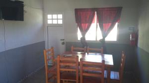 a dining room table with two chairs and a window at Susurro de Montaña (TIERRA SANTA) in San Lorenzo