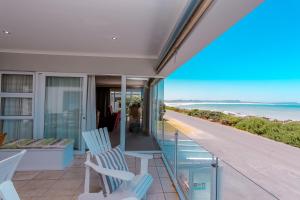 a balcony with chairs and a view of the ocean at Franskraal B&B in Gansbaai