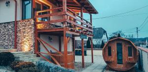 a building with a wooden staircase on the side of it at Vendégház Harsány in Harsány