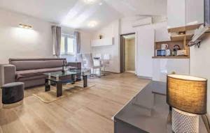 a living room with a couch and a table at Apartments EDEN in Šišan