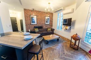 a living room with a brick wall at Jacuzzi-Nice quartier des musiciens-Loft in Nice