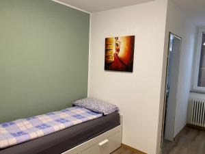 a bedroom with a bed with a picture on the wall at Ristorante Del Ponte in Cugnasco