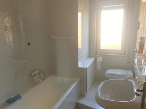 a bathroom with a tub and a toilet and a sink at Casamare San Giorgio in Sciacca +26 photos