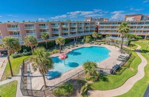 an aerial view of a hotel with a pool and a resort at Beach Escape - Top floor Ocean views - Heated pool - Seawall Blvd in Galveston