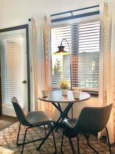 a table and chairs in a room with a window at DOCO Rocky Mountain Vacation Rental-King Room with Resort Amenities in Granby