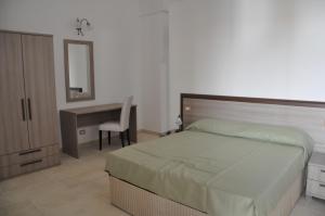 a bedroom with a bed and a desk and a chair at Agriturismo Marconi in Porto Cesareo +20 photos