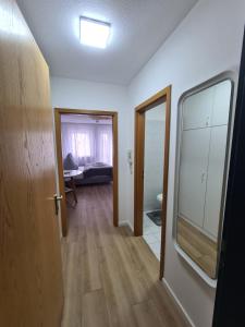 a room with a hallway with a mirror and a door at South Apartment - Modern & Stylish in Augsburg
