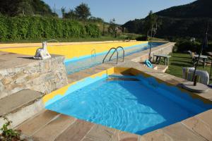 a swimming pool with a blue and yellow at Agriturismo Gallo in Cortemilia