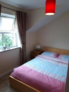 a bedroom with a large bed and a window at Beautiful Seaview Penthouse Apartment in Bundoran