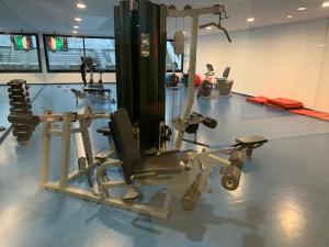 a gym with several tread machines in a room at Green Life Full Amenities in Punta del Este