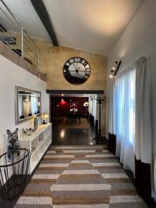 a hallway with a large clock on the wall at BLB Loft Luxury House in Villenave-dʼOrnon +24 photos