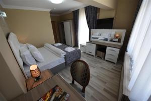 a small bedroom with a bed and a table and a chair at Hotel Selimpaşa Konağı in Silivri