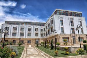 a large white building with a courtyard in front of it at Hotel Selimpaşa Konağı in Silivri