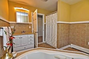 a bathroom with a tub and a shower and a sink at Charming Cottage Historic Falmouth Cape Cod Near Beach and Downtown 2BR 1Bath Deck in Falmouth