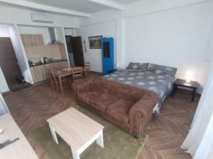 a living room with a couch and a table at Mini Loft in Becerril de la Sierra