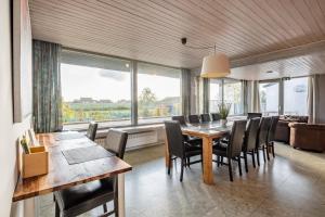 uma sala de jantar com uma mesa e cadeiras e um sofá em Flanders Fields Cottage em Beveren