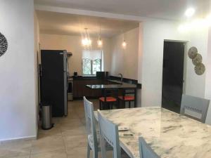 a kitchen and dining room with a table and chairs at Amazing 3 bedroom apartment with great pool in Cancún