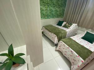 Ένα ή περισσότερα κρεβάτια σε δωμάτιο στο Mandakaru Flats De Luxo +63 φωτογραφίες