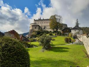 a castle on top of a lush green field at Vor den Toren Salzburgs in Wals