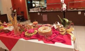 a table with a red table cloth with food on it at Tree Bies Resort, Simplesmente Maravilhoso! in Entre Rios