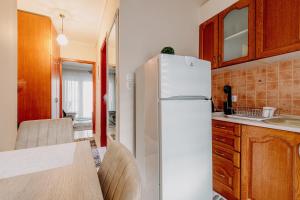 a kitchen with a white refrigerator and a table at Your House in Komotini