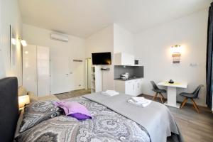 a bedroom with a bed and a table and chairs at Deluxe Apartments Ria in Zagreb