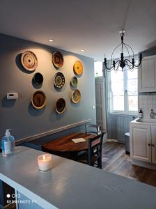 a kitchen with plates hanging on the wall at La petite maison du Quai in Blois