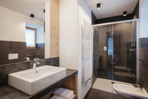 a bathroom with a sink and a shower at Berghotel Sanví in San Martino in Badia