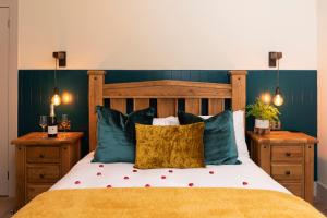 a bedroom with a large bed with blue walls and two night stands at Station View, Dunblane in Dunblane