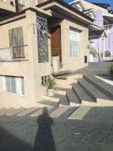 a shadow of a person walking in front of a house at San Francisco in Comodoro Rivadavia