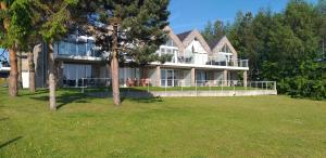 a large house with a large lawn in front of it at Nadmorski Klif in Mechelinki