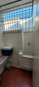 uma casa de banho com uma banheira, um WC e uma janela. em Praia do Forte e boemia da Passagem em Cabo Frio